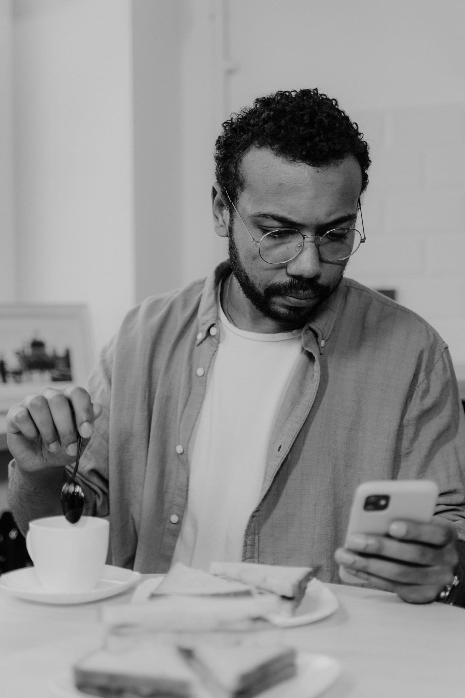 Dating for entrepreneurs: founder checking a phone at a café table in the evening